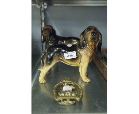 A MELLA WARE PORCELAIN STANDING DOG, ANOTHER SIMILAR AND A JOHN PEEL BRASS DOOR KNOCKER (3) 