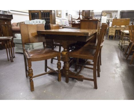 A CIRCA 1940's CARVED OAK DINING ROOM SUITE OF SIX PIECES, COMPRISING; A DRAW-LEAF TABLE, FOUR CHAIRS AND A SIDEBOARD 