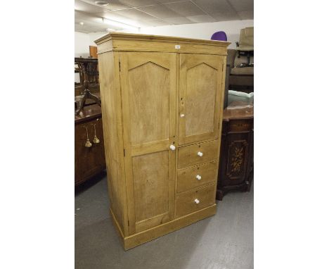 A SMALL PINE COMBINATION WARDROBE, WITH CUPBOARD AND THREE DRAWERS 
