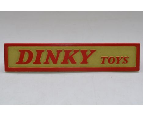 Vintage Dinky Toys triangular cross-section shop counter display sign, L175xH32xW36mm, cast metal with rubber feet, excellent