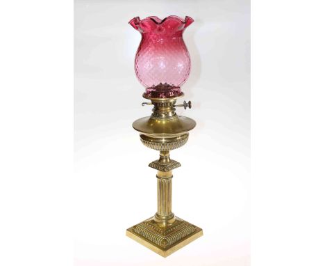 Brass oil lamp with cranberry glass shade