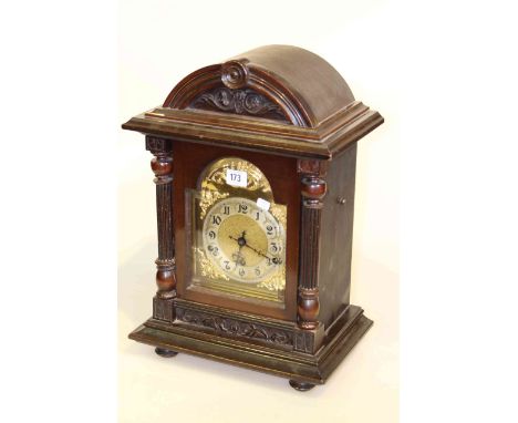 Mahogany bracket style mantel clock with embossed brass dial