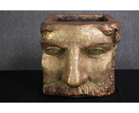 A planter in the form of a classical mask finished in gold. H.36 W.36 D.45cm. 