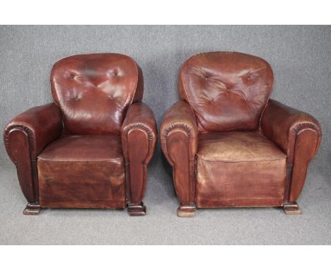 Armchairs, a pair mid century vintage in buttoned leather and studded upholstery. H.85 W.90cm. (each) 