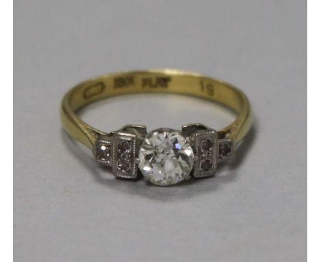 An 18ct gold single stone diamond ring with diamond set shoulders, stamped 18ct Plat