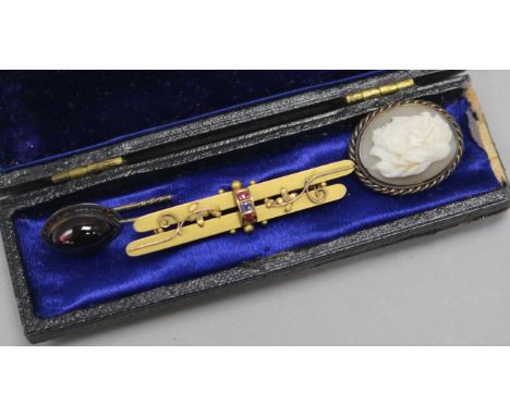 A Victorian gold, ruby and sapphire bar brooch and two stick pins