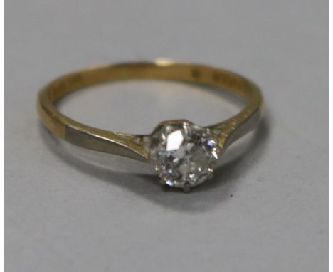 An 18ct gold and platinum solitaire diamond ring, stamped 18ct pt