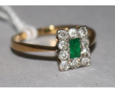 An 18ct gold emerald and diamond plaque ring