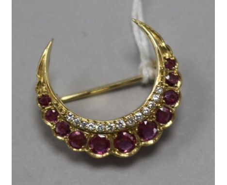A gold, ruby and diamond crescent brooch