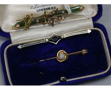 A jade, split pearl and gold brooch, a gold and opal brooch and one other