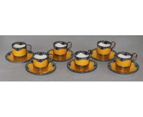 A set of six Royal Worcester silver-mounted coffee cans and saucers, with six enamelled silver-gilt coffee spoons, the yellow