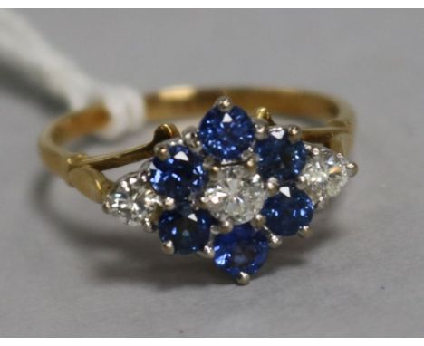 An 18ct gold sapphire and diamond cluster ring