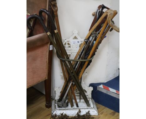 A Victorian cast iron stick stand and sticks