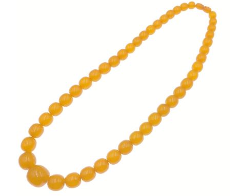 A strand of VINTAGE AMBER BEADS! This wonderful necklace is comprised of vibrant amber beads, which are hand-strung to form a