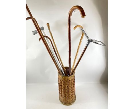 A collection of old walking sticks to include a VINTAGE shooting stick etc - all within a small wicker basket!