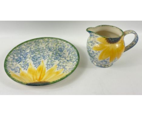 A hand-painted POOLE POTTERY plate (22cm dia) and matching milk jug (height 11cm) in a pattern of blue and green with sunflow