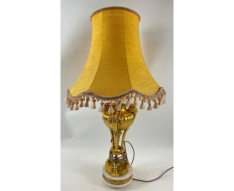 An ornate table lamp with marble base, gilt supports leading to rams' heads anda raw silk shade, stands approx 65cm tallAppro