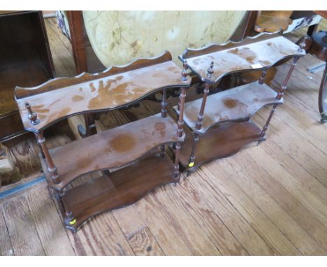 A pair of small mahogany serpentine wall shelves, each with three tiers on turned supports 48cm wide and an oak corner shelf