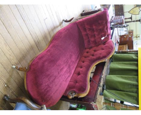 A mid Victorian walnut button back chaise longue, the scrolling back and arm carved with acanthus leaf above a shaped seat, c