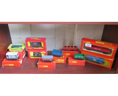 Triang and Hornby: nine wagons including Pedigree Prams container, Wheel-load Flat Wagon and Johnnie Walker Grain, eight in o