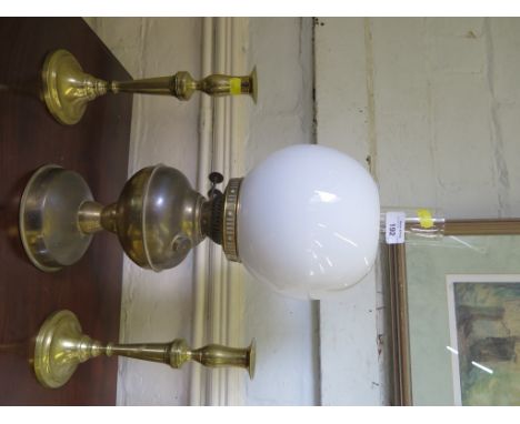 A pair of brass candlesticks, 26cm high and a brass oil lamp