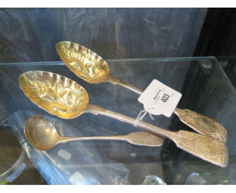 A pair of silver gilt Victorian berry spoons with engraved crest, hallmarked for 1861 and a Georgian small sauce ladle (3)