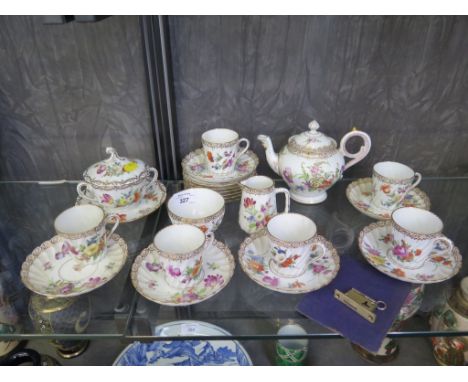 A Dresden tea service, the spiral form cups and saucers painted with floral sprays, including teapot, bowls and jug