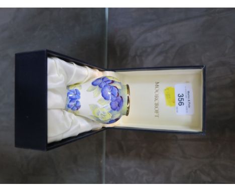 A Moorcroft enamel Pansy design baluster vase, 6.5cm high in original box