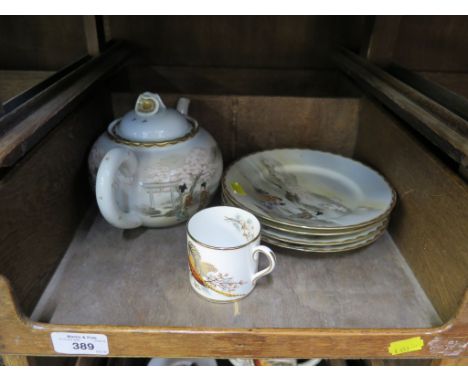 A Satsuma china teapot and four plates all with figures in garden landscapes