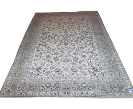 FINE KASHAN CARPET, 392cm x 298cm, of palmettes and vines on ivory field and jade border, signed.