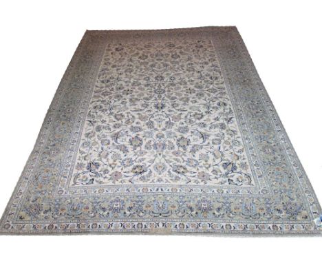 FINE KASHAN CARPET, 392cm x 298cm, of palmettes and vines on ivory field and jade border, signed.