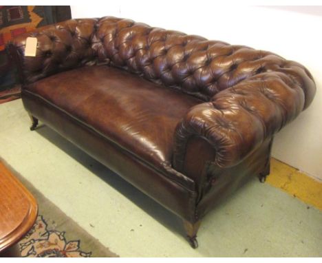 DROP END CHESTERFIELD SOFA, Victorian walnut and tan brown leather upholstered with deep button back and arms, one adjustable