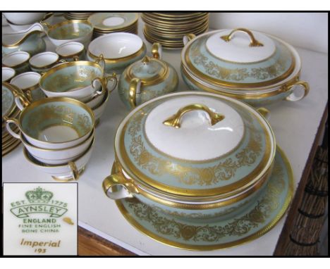 AYNSLEY 'IMPERIAL' DINNER/TEA SERVICE, eight place setting with gilt detailed turquoise rims, including serving plates and di