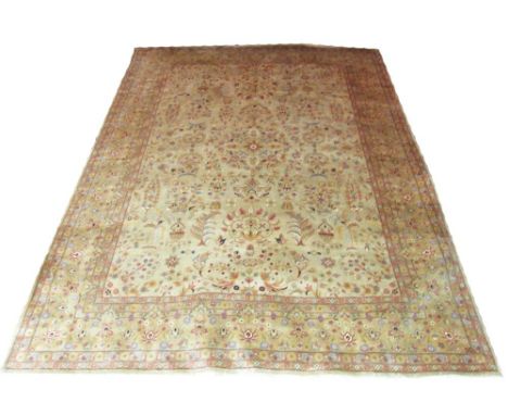 MIRSAPOOR CARPET, 361cm x 270cm, of scrolling vines, trees and floral motifs on a golden field and corresponding border.