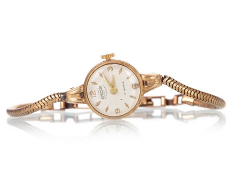 ENICAR, NINE CARAT GOLD MANUAL WIND WRIST WATCH,  the round dial with baton and Arabic hour markers, 17mm case, on a nine car