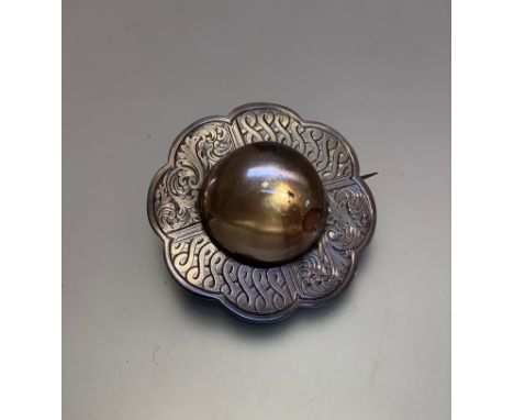 A large Victorian white metal Celtic style scalloped brooch with crystal cabuchon, (d 6cm)
