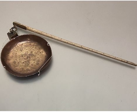 A 19thc Chinese bone mounted brass balance set of scales with single brass weight, the pan with stylised bell design with fla