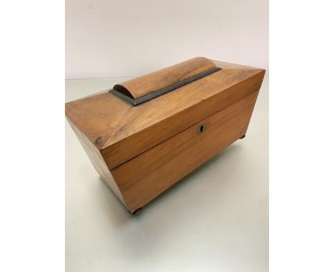 A 19thc walnut sarcophagus shaped tea caddy, the interior fitted with centre open aperture flanked by tea section with lift o