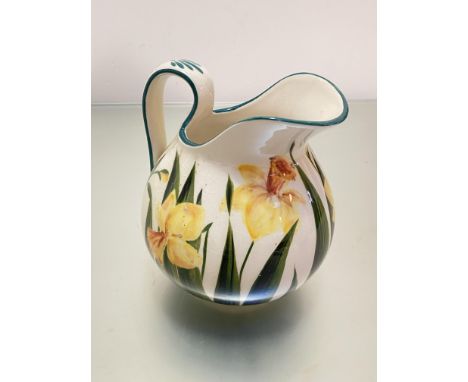 A Griselda Hill Wemyss style pottery ewer decorated with daffodil design, (h 17cm x 18cm x 16cm)
