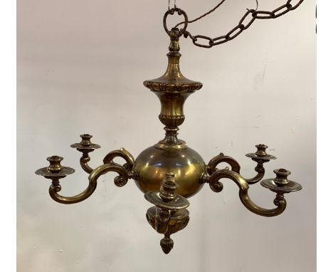 A Large Dutch style brass chandelier, the central column of gadrooned baluster form issuing six scrolled branches, H74cm, D77