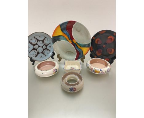 A collection of three Poole Pottery plates decorated with stylised modern designs, (largest d 28cm) and three various Poole f