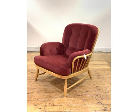 Ercol, a light beech and elm lounge easy chair, with hoop and spindle back and arms, fitted cushions, raised on turned and ta