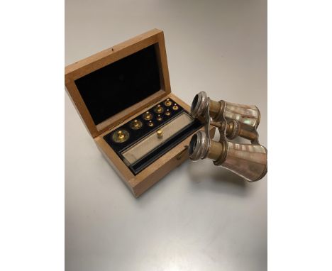 A satinwood box containing nine various miniature weights, complete with fittings etc, and a pair of mother of pearl mounted 