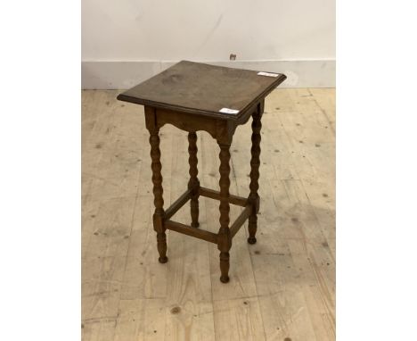 An early 20th century oak lamp table, the square top raised on bobbin turned and block supports, H49cm, 30cm x 30cm