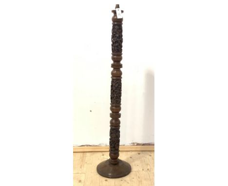 An unusual African turned hardwood (probably padauk) lamp standard, relief carved with figures, on a turned base, H127cm