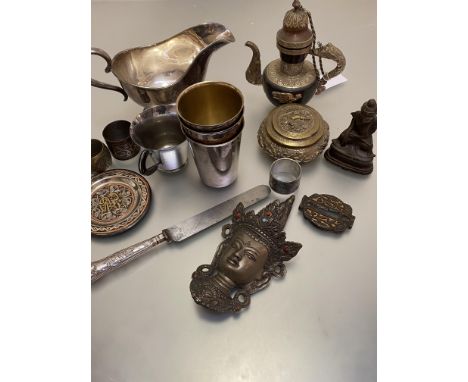 A Sheffield silver handled steel bladed knife, a chromium plated cup and an Eastern cast metal Buddhist style head, three Epn