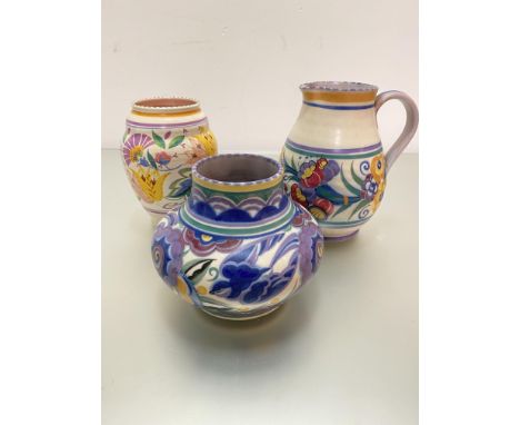 A Poole pottery baluster handpainted jug with stylised floral band, impressed mark verso Carter Stables Poole, a squat vase d