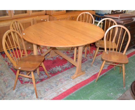 An Ercol dropleaf table and five chairs with protective leather table covers