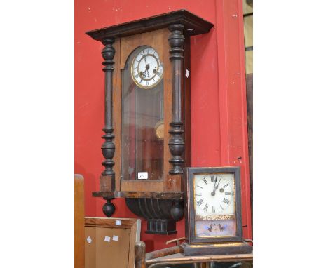 An early 20th century walnut Vienna wall clock, white enamel dial. outer minute track, Roman numerals, eight day movement; an