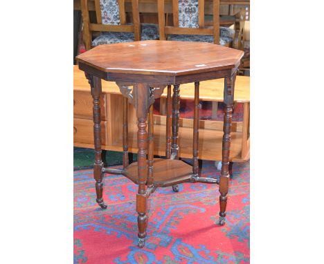 A Victorian mahogany octagonal centre table, turned supports and columns, octagonal undertier, ceramic casters, circa 1880